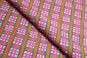 Beach Blanket linen by Bethie Tricks in pink and orange, draped, showing a bold check