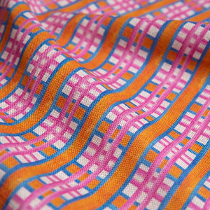 Beach Blanket linen by Bethie Tricks in pink and orange, in soft folds showing a bold check