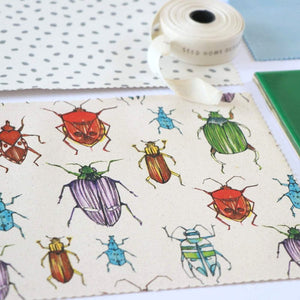 Beetle fabric by Seed Home Designs in red, blue and green, full repeat of watercolour beetles