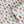 Beetle wallpaper by Seed Home Designs in red, blue and green, roll showing watercolour beetles
