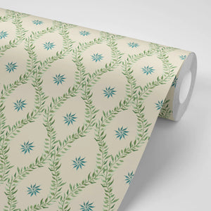Belle wallpaper by Tatie Lou in sage green, partly unrolled roll showing an ornate ogee trellis