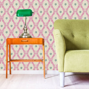 Belle wallpaper by Tatie Lou in pink, an ornate ogee trellis behind a sofa in a living room