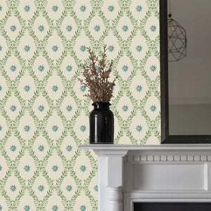 Belle wallpaper by Tatie Lou in sage green, an ornate ogee trellis around a fireplace