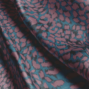 Leopard velvet by Tatie Lou in burgundy, draped, showing a leopard-spot print