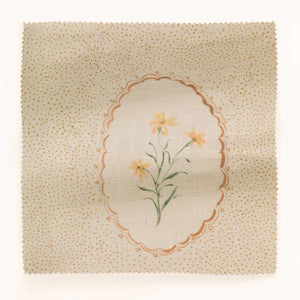 Bibury Sprig linen by Parker and Jules in beige, in soft folds showing embroidered flowers in ovals