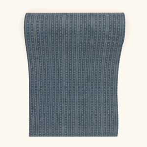 Birdlip wallpaper by Parker and Jules in black, partly unrolled roll showing a small block-print stripe
