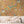 Birds in Paradise wallpaper by Brand McKenzie in gold, tropical birds on blossoming branches above a sideboard