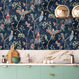 Birds in Paradise wallpaper by Brand McKenzie in navy, tropical birds on blossoming branches above a sideboard