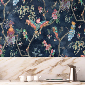 Birds in Paradise wallpaper by Brand McKenzie in navy, tropical birds on blossoming branches above a cabinet