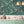 Birds in Paradise wallpaper by Brand McKenzie in teal, tropical birds on blossoming branches above a sideboard