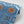 Nui Burst wallpaper by Tatie Lou in blue and orange, roll showing shibori-style bursts