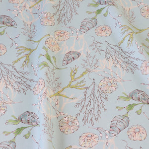 Coastal Cove fabric by Seed Home Designs in blue, full repeat of line-drawn shells and seaweed