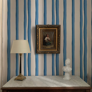 Somerset Stripes wallpaper by Annika Reed in blue, painted stripes above a sideboard