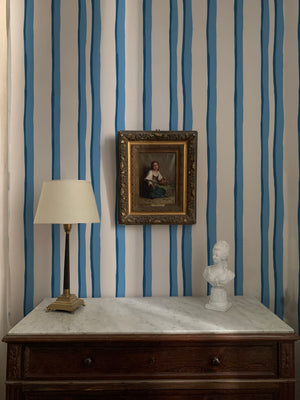 Somerset Stripes wallpaper by Annika Reed in blue, painted stripes above a sideboard