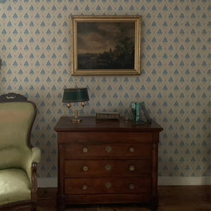 Agra wallpaper by Annika Reed in pink, block-print flowers in a trellis above a sideboard