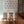 Winged Lion wallpaper by Annika Reed in blue, winged lions behind a console table