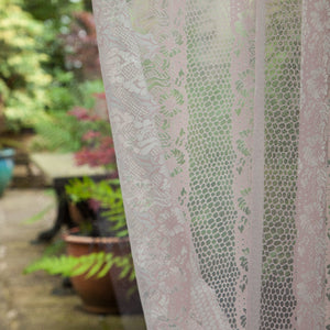 Body Lace voile fabric by The Monkey Puzzle Tree in pink, a lace body print hung as curtains