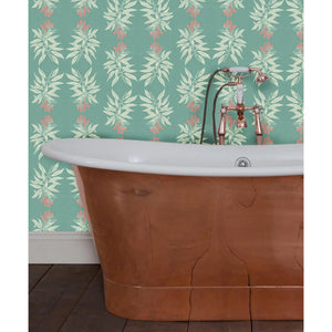 Branch of Mango wallpaper by Annika Reed in teal, mango branches in a bathroom