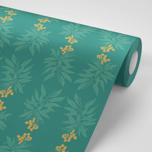 Branch of Mango wallpaper by Annika Reed in teal and orange, partly unrolled roll showing mango branches