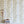 Monkeys and Birds wallpaper by St. Jude's in green, monkeys and birds on stems above a sideboard