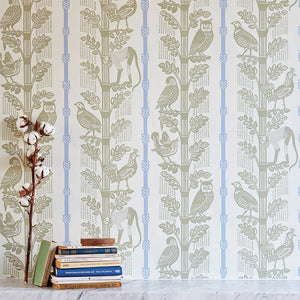Monkeys and Birds wallpaper by St. Jude's in green, monkeys and birds on stems above a sideboard