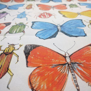 Beetle and Butterfly fabric by Seed Home Designs in red, blue and green, flat sample of watercolour beetles and butterflies