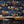 Canine Cards wallpaper by Brand McKenzie in navy, dogs playing cards behind a desk in a home office