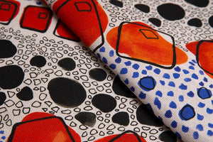 Cellular linen by Bethie Tricks in orange and black, flat sample of bold cell shapes