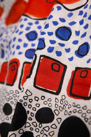 Cellular linen by Bethie Tricks in orange and black, close-up of bold cell shapes