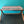 Cellular linen by Bethie Tricks in orange and black, bold cell shapes covering a footstool