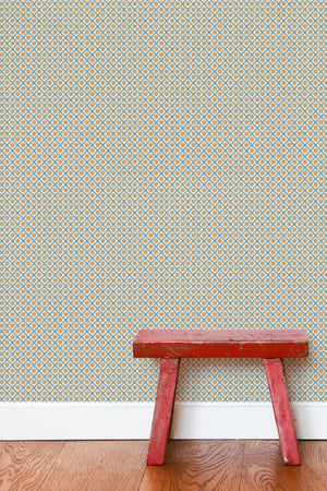 Solstice Sun wallpaper by Annika Reed in grey, suns in a lattice in a hallway