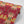 Hampi wallpaper by Tatie Lou in red, roll showing tropical flowers in a mirrored print