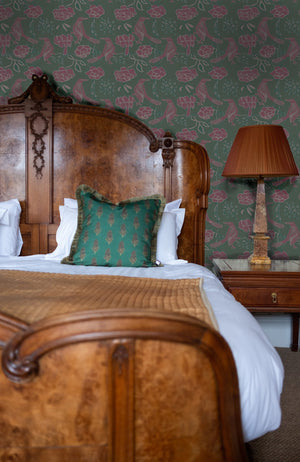 Chattering of Choughs wallpaper by Annika Reed in teal and pink, choughs among leaves in a bedroom