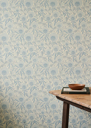 Clover wallpaper by St. Jude's in blue, clover leaves and flowers behind a console table