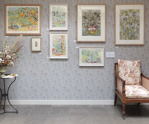 Clover wallpaper by St. Jude's in pale green, clover leaves and flowers in a styled room setting