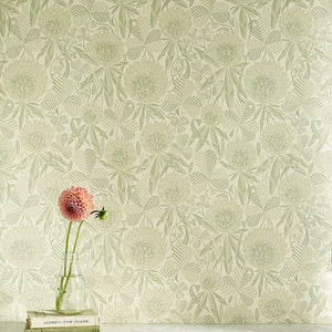 Clover wallpaper by St. Jude's in pale green, clover leaves and flowers above a sideboard