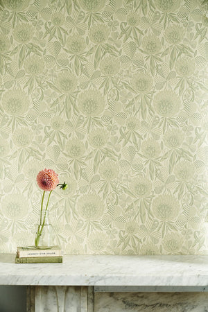 Clover wallpaper by St. Jude's in pale green, clover leaves and flowers above a sideboard