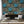 Club Safari wallpaper by Brand McKenzie in turquoise, a lush safari scene in a living room