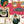 Connecting Frames wallpaper by Brand McKenzie in pink, detail of a gallery wall of framed portraits