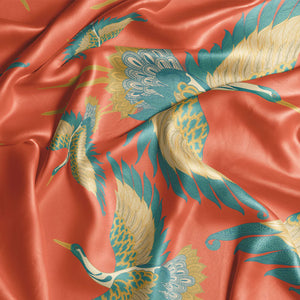 Pachamama velvet by Tatie Lou in coral, draped close-up of flying cranes