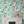Cosmic Groove wallpaper by Brand McKenzie in aqua, retro figures floating in space above a white mantelpiece