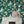 Cosmic Groove wallpaper by Brand McKenzie in dark green, close view of retro figures floating in space