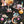 Cosmic Groove wallpaper by Brand McKenzie in black, close-up of retro figures floating in space