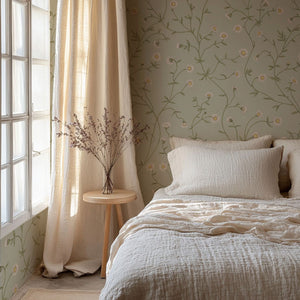 Daisy Chain wallpaper by Studio Le Cocq in pale green, trailing daisy chains in a bedroom
