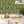 Crab Cabana wallpaper by Brand McKenzie in olive, close view of crabs under scalloped arches