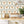 Crab Cabana wallpaper by Brand McKenzie in beige, crabs under scalloped arches in a kitchen