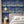 Creature Club wallpaper by Brand McKenzie in blue, animals on a checkerboard stage on a bedroom wall