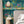 Creature Club wallpaper by Brand McKenzie in green, animals on a checkerboard stage in a bedroom