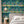Creature Club wallpaper by Brand McKenzie in green, animals on a checkerboard stage behind a bed