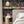 Creature Club wallpaper by Brand McKenzie in grey and black, animals on a checkerboard stage on a bedroom wall